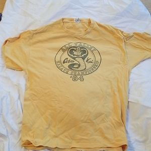 Yellow Cobra Kai t-shirt.
